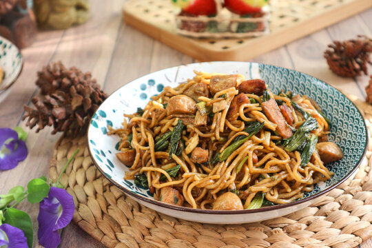 Indonesian-style stir-fried noodles, or mie goreng, also known as bakmi goreng. It's made with thin noodles, meatballs, and choy sum, tossed in sweet soy sauce.