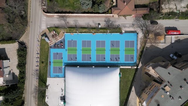 Top Down Aerial View of People Playing Pickleball on Blue Courts
