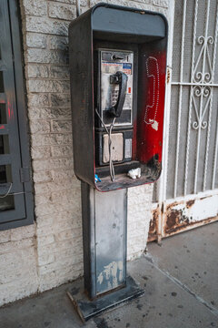 Old phone both on city streety