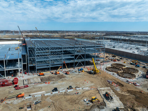 Mount Pleasant, Wisconsin, USA - April 11, 2026: Construction continues on a Microsoft data center expansion, showing steel framework, cranes, and active development on site.