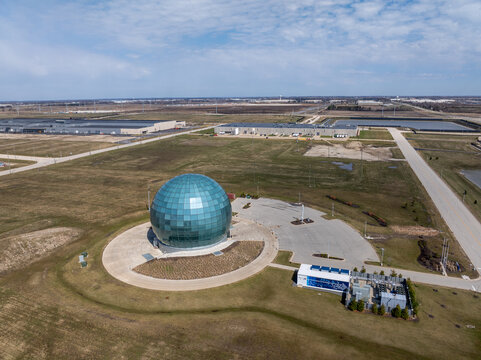 Mount Pleasant, Wisconsin, USA - April 11, 2026: Aerial view of the Foxconn campus featuring a glass sphere building surrounded by undeveloped land and industrial facilities.