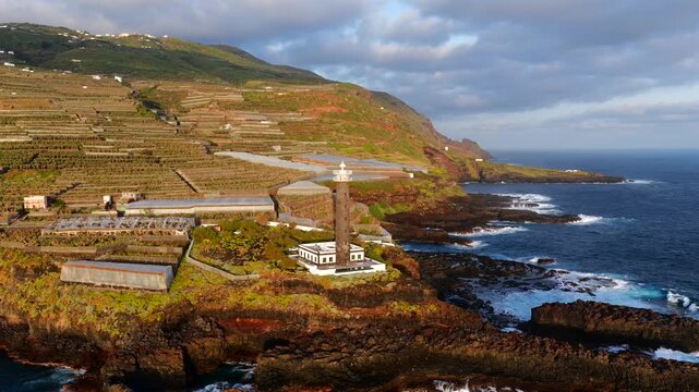 Aerial View of La Fajana Lighthouse and Coastal Banana Plantations at Sunrise; Maritime Infrastructure, Industrial Agriculture, and Solar Azimuth, La Palma, Canary Islands, Spain