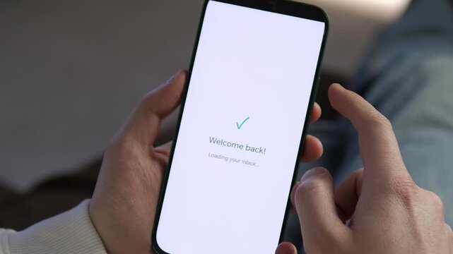 User gains access to their account on a smartphone. Welcome back screen with a green checkmark loading the inbox. Ideal for concepts of digital security, user experience, and seamless mobile