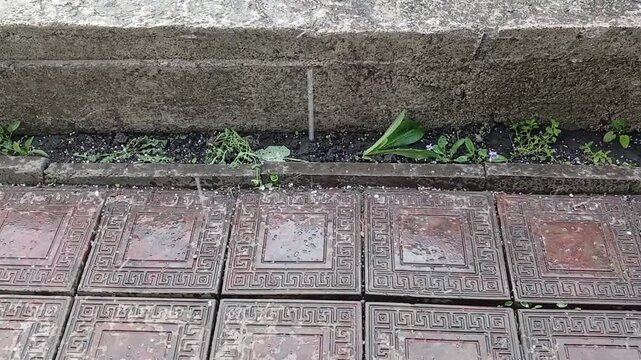Stock video of hail falling in the yard on the tiles