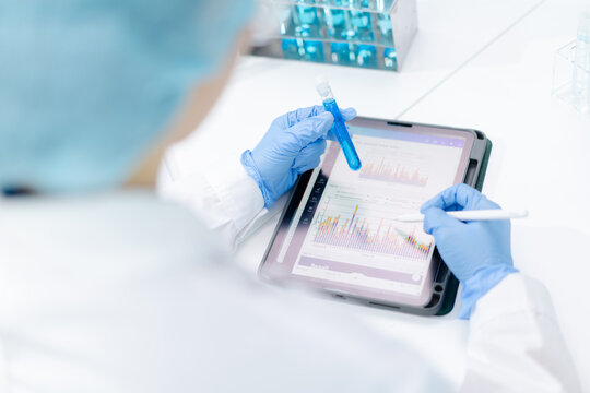 hand of scientist hold test tube with liquid chemical water to recheck experiment result in laboratory, doctor with blue glove research and analyze biochemistry for healthcare and medical innovation