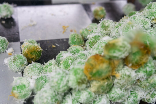 Traditional Indonesian Klepon balls, boiled rice cakes stuffed with liquid palm sugar. Traditional Indonesian Klepon balls, boiled rice cakes stuffed with liquid palm sugar.