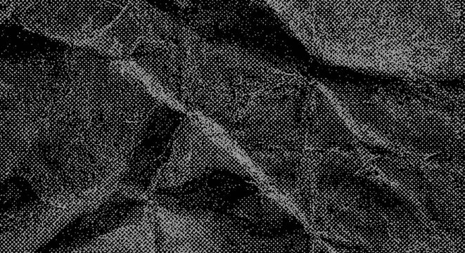 A close-up view of a dark crumpled paper texture with deep folds