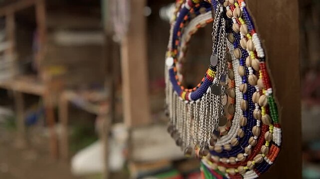Vibrant handcrafted African beadwork necklaces showcased at an open-air market for tourists and buyers in Amboseli, Kenya