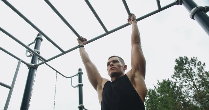 Fitness and sport lifestyle. Sports, health care, fitness routine, workout. Daily exercise to keep fit. Fitness Sport Street Workout. Muscle Up In Public Gym. Strength, motivation. Outdoors gym.