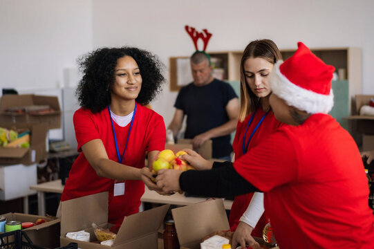 Holiday charity event with festive atmosphere showing teamwork, humanitarian aid and community support.
