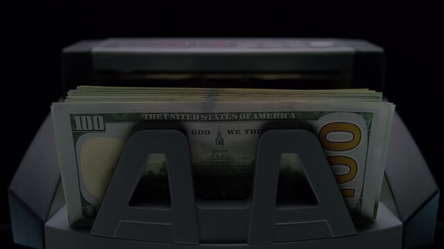Money counter machine with stack of dollars