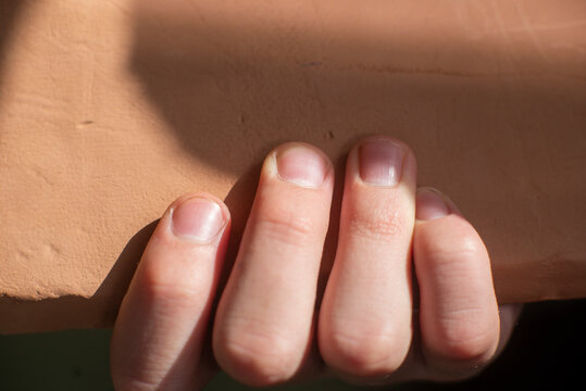 Hand holding clay block, creation and shaping concept