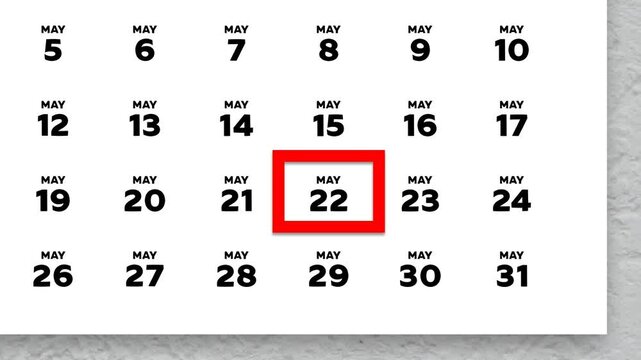 The date May 22nd marked with a red cursor on the wall calendar 2026