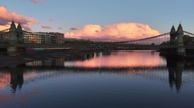 London, UK - April 20 2026: 4K aerial drone footage of Hammersmith Bridge and the Thames at sunset