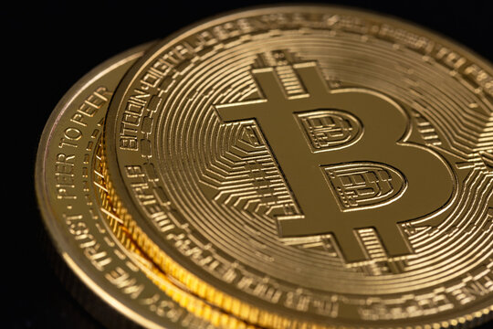 bitcoin cryptocurrency symbol closeup on a black background.