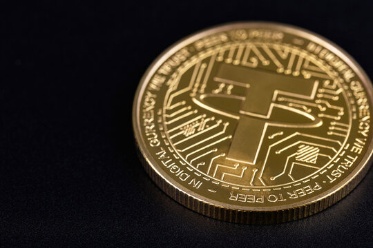 USDT, Tether logo on a metal coin cryptocurrency closeup on a black background. Tether is a cryptocurrency token issued by Tether Limited. Batumi, Georgia - March 18, 2026
