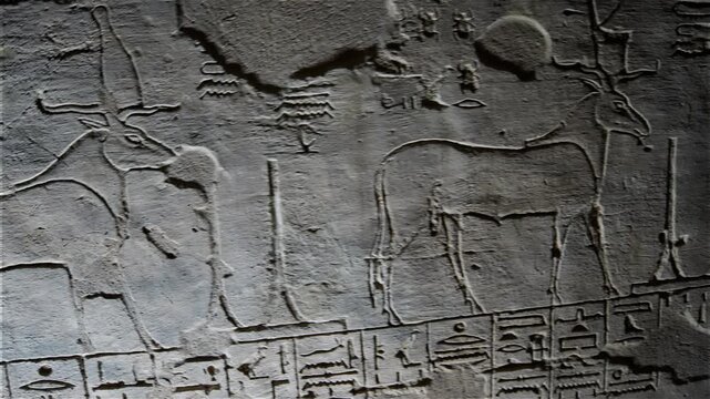 Burial chamber of KV14 royal tomb, Valley of the Kings, Luxor, Egypt, with vivid murals of Egyptian gods, winged goddess Isis, pharaoh figures, hieroglyphics on golden yellow walls.