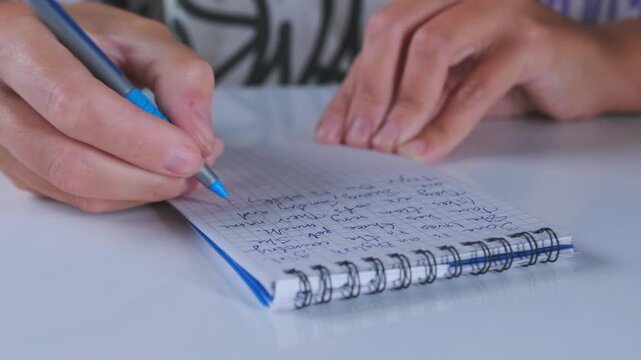 close-up of hands writing notes in notebook with pen, taking notes on paper, planning tasks, studying or working, productivity concept, education and organization lifestyle