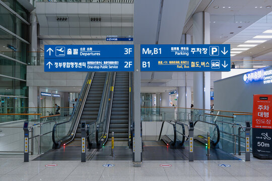 April 14, 2026, Incheon, South Korea - Interior view of Incheon Airport Terminal 2 with escalators and directional signs for departures, parking, rail, and bus services.