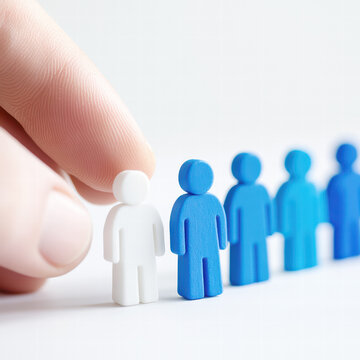 Finger gently selects one white figure from a line of blue