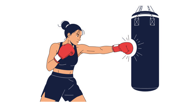 Strong female athlete wearing red boxing gloves practices her punches on a heavy black bag in a fitness studio or training gym.