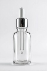 Naklejka premium Clear glass bottle with silver dropper cap