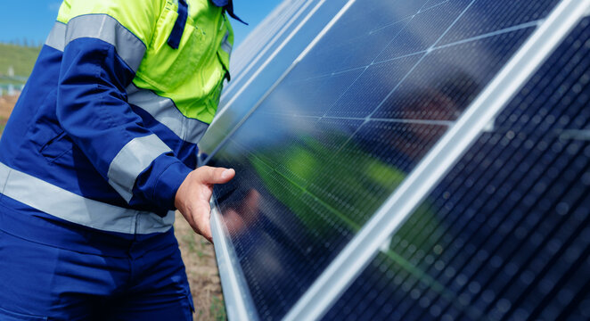 Worker on solar panel installation in outdoor renewable energy setup, eco energy efficiency