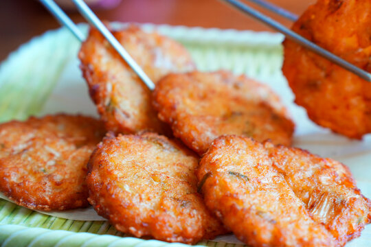 Korean traditional mung bean pancakes Bindaetteok being picked up with chopsticks