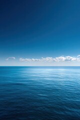 Obraz premium Clear blue sky meets calm ocean waters