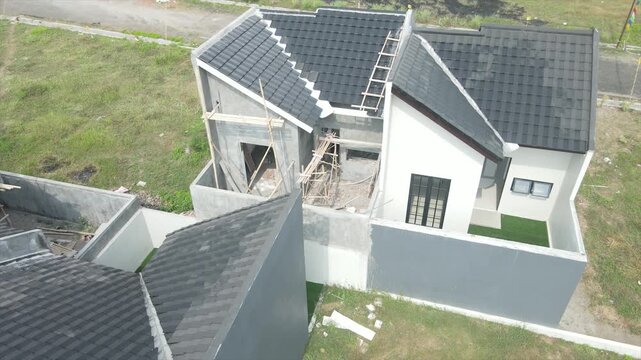 Top down aerial view of modern residential house construction in a rural suburban area.