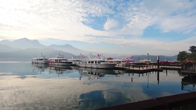Sun Moon Lake Pier with Boats and Mountain Reflection at Sunrise in Taiwan