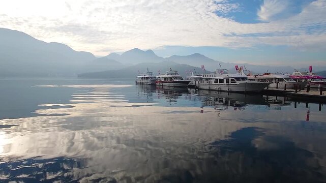 Sun Moon Lake Pier with Boats and Mountain Reflection at Sunrise in Taiwan
