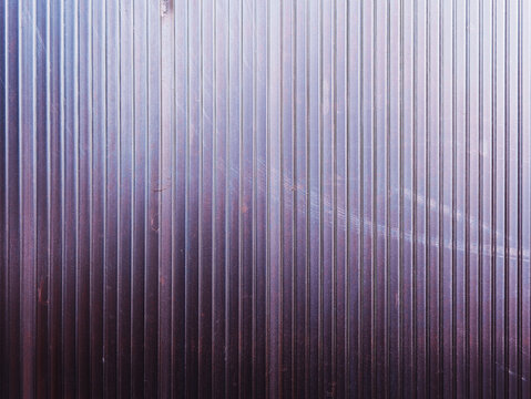 Vertical purple metallic panel with some scratches backdrop