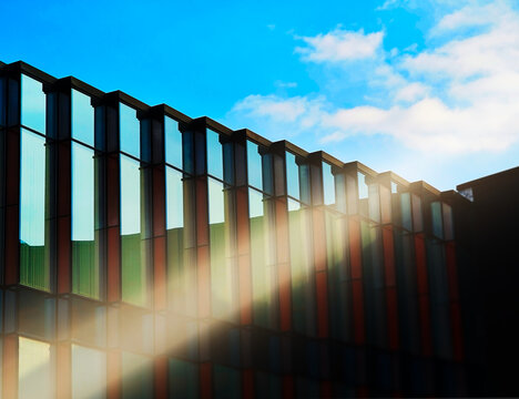 Ray of light falling on modern glass building backdrop
