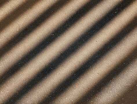 Diagonal light rays on the street asphalt background