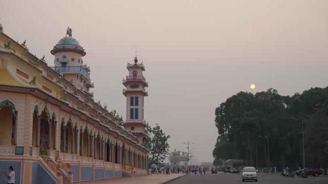 Long corridor and temple tower with warm sky static shot Tay Ninh Vietnam travel architecture