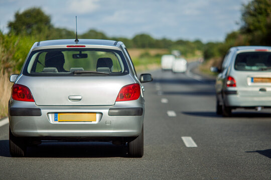 Silver Car on N165 E60 Road, Brittany, France. Automotive Travel.