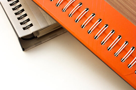 Close-up photo of spiral bound paper catalogue on white background.