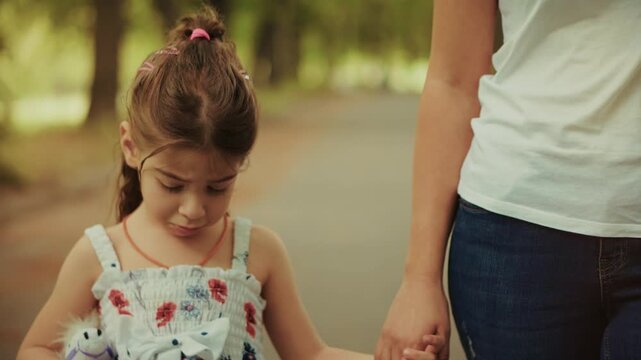 Kid Carrying Toy With Mother Walking Together In Summer Park. Family Time And Parenting