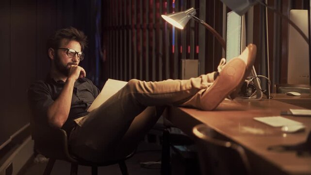 Businessman Relaxing In Evening Office. Manager Thinking About Project Strategy