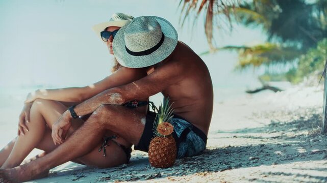 Travelers Relaxing on Sandy Beach near Tropical Palm Trees. Summer Vacation and Romantic Getaway