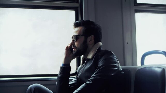 Man Talking on Smartphone While Commuting by Train. Telecommunication and Urban Transportation