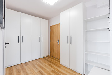 Modern hallway featuring white built in wardrobes and minimalist design