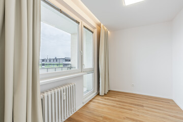 Empty room presenting minimalist interior design with window and hardwood floor