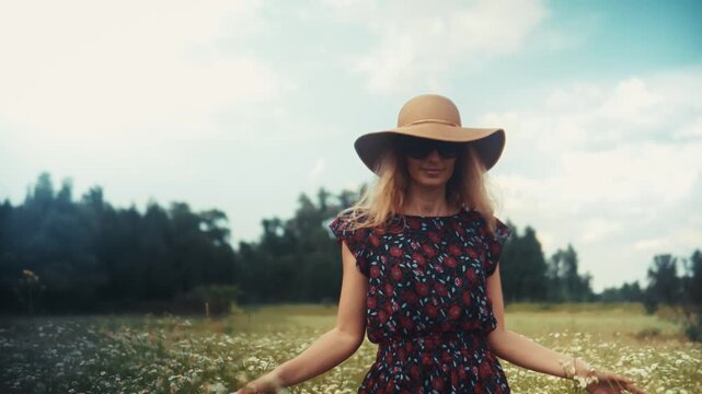Woman Walking Through Wildflower Meadow. Outdoor Recreation And Leisure Activity