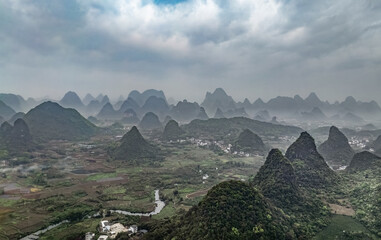 Obraz premium lush green valley surrounded by towering mountains. China.