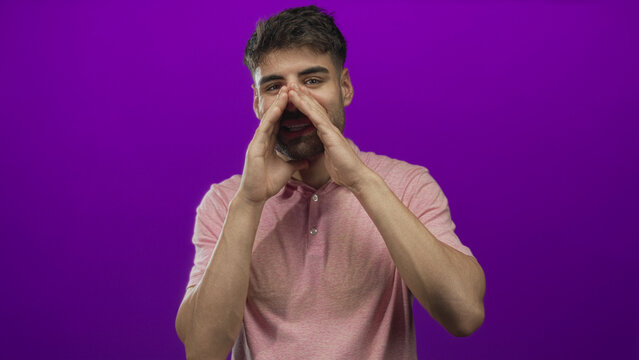 Bearded hispanic man cupping hands to mouth calls in a purple studio; urgent announcement communication energy.