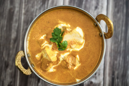 Traditional Indian vag and chicken curry served with naan flat bread. Indian curry, chicken tikka masala with rice and naan bread. Dark background. Copy space.