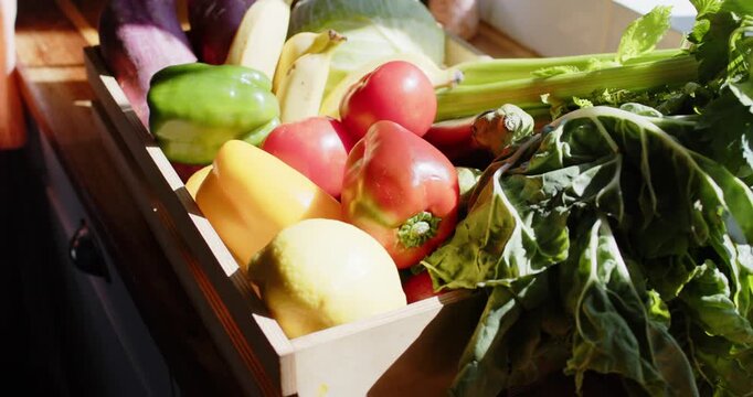 Wooden crate sitting on kitchen counter, camera shifting and sun rising, showing tomato textures