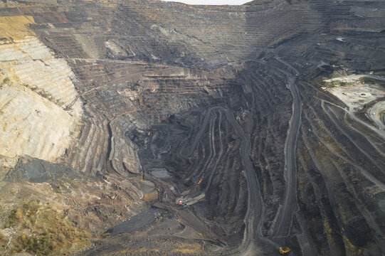 Aerial view of a massive open-pit coal mine featuring terraced rock walls and winding industrial roads Santa Lucia de Gordon, Castile and Leon, Spain.